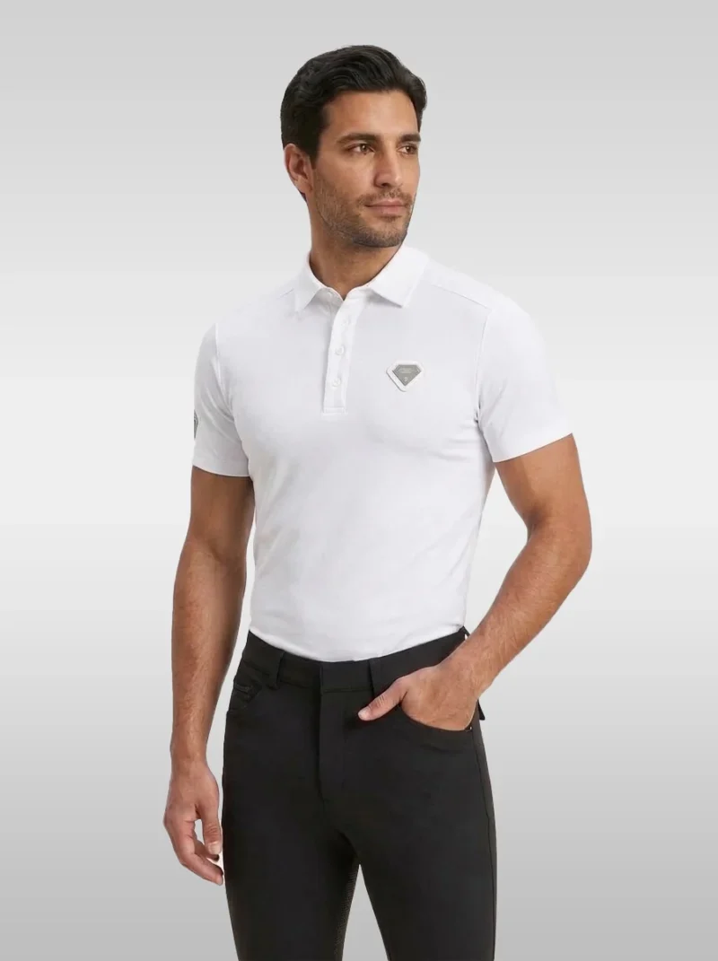 White Cavalier men’s equestrian polo shirt by Diamont Equestrian with silver diamond chest badge, front three-quarter view