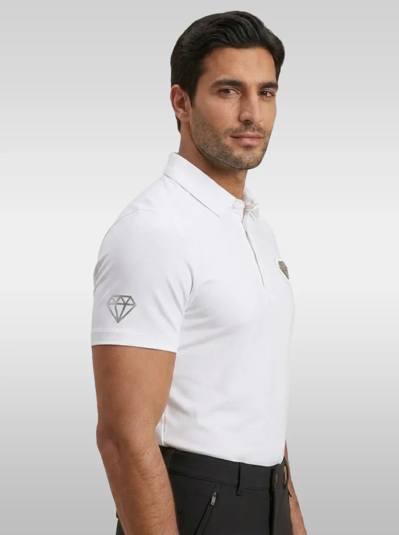 Side view of the white Cavalier men’s riding polo showing the diamond logo on the sleeve and the chest badge