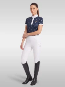 Rider wearing the navy Diamont base layer with white riding breeches and tall black riding boots, full body