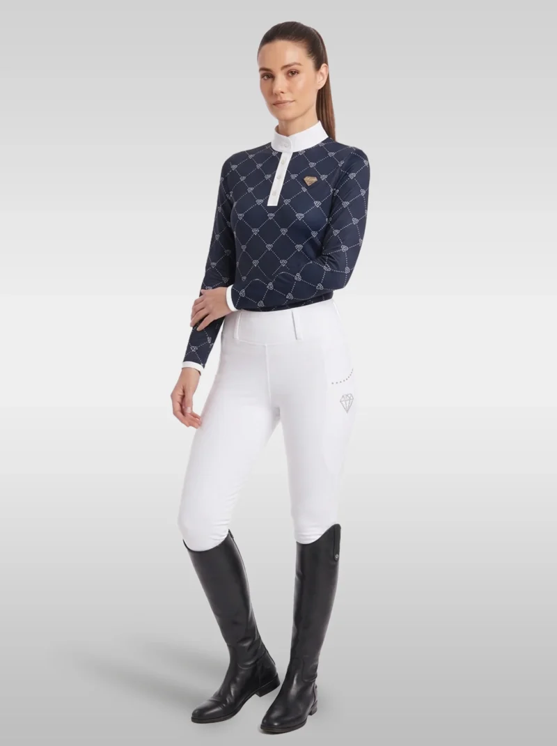 Rider wearing the navy Diamont long sleeve base layer with white riding breeches and tall black riding boots, full body