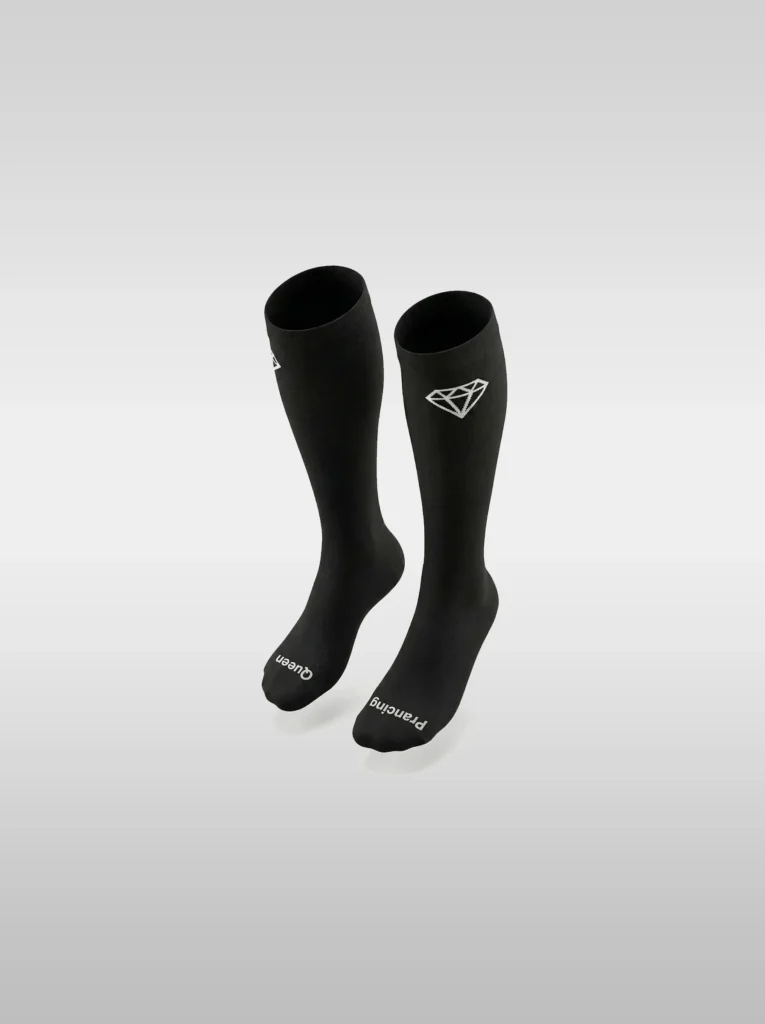 Black Diamont Equestrian EquiChic knee-high riding socks with the "Prancing Queen" phrase on the sole and diamond logo at the top