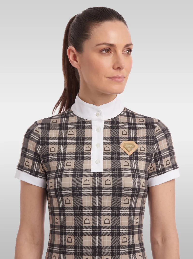 Front view of the beige Heritage check equestrian base layer with white buttoned placket, stand-up collar and gold diamond badge