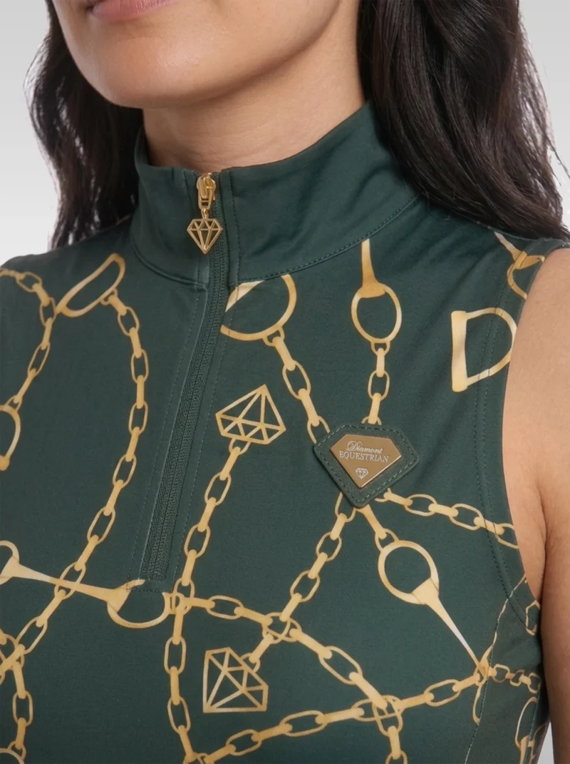 Close-up of the green Signature sleeveless base layer: stand-up collar, quarter-zip with gold diamond pull, chain and stirrup print and gold metal diamond badge
