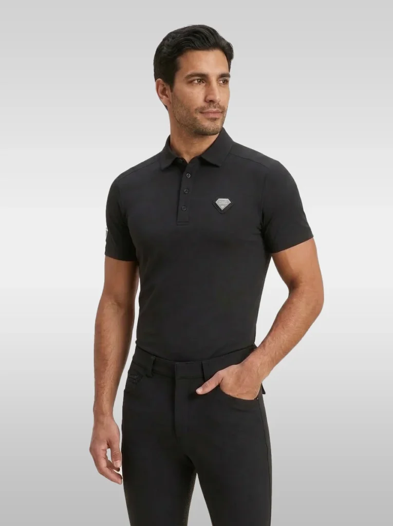 Black Cavalier men’s equestrian polo shirt by Diamont Equestrian with silver diamond chest badge, front three-quarter view