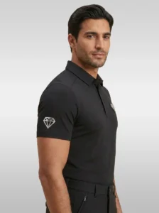 Side view of the black Cavalier men’s riding polo showing the diamond logo on the sleeve and the chest badge