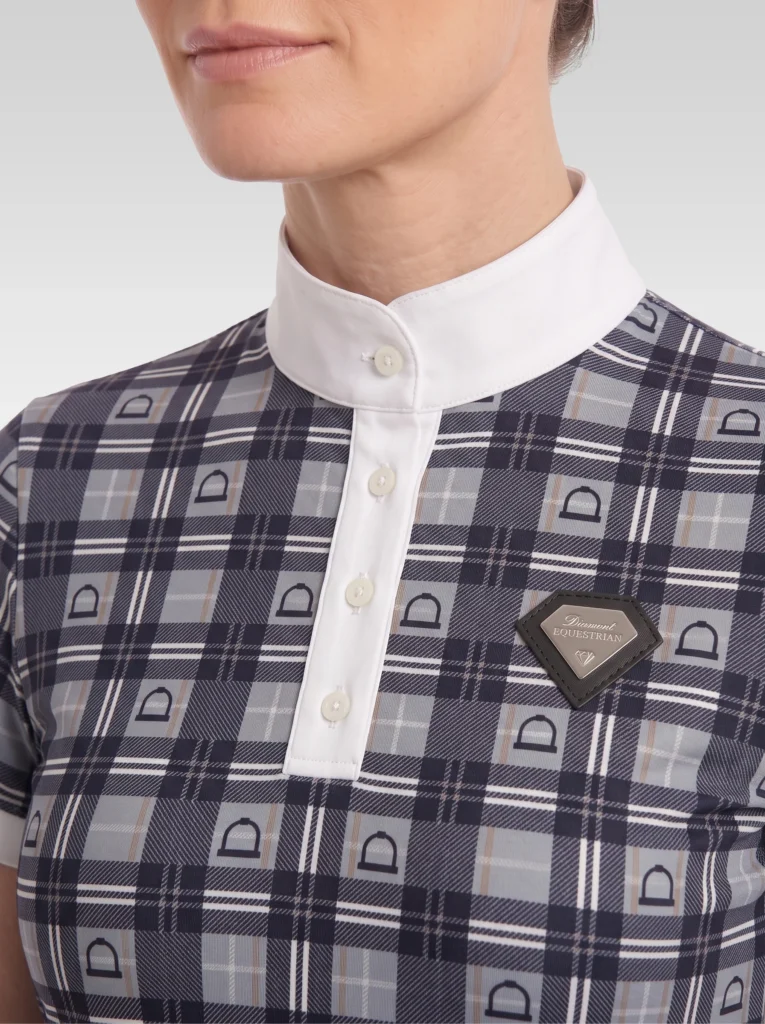 Close-up of the grey Heritage base layer: white stand-up collar, button placket, check print with stirrup motif and silver metal diamond badge