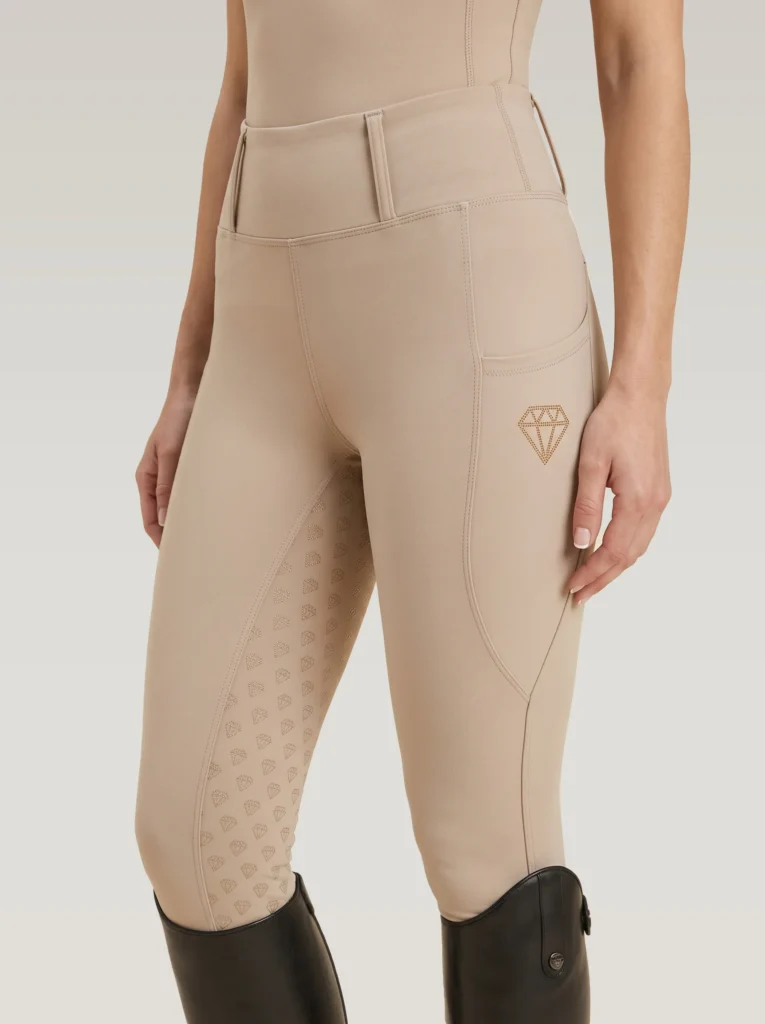 Beige Prestige riding leggings by Diamont Equestrian with diamond logo on the side pocket and diamond silicone grip, front three-quarter view