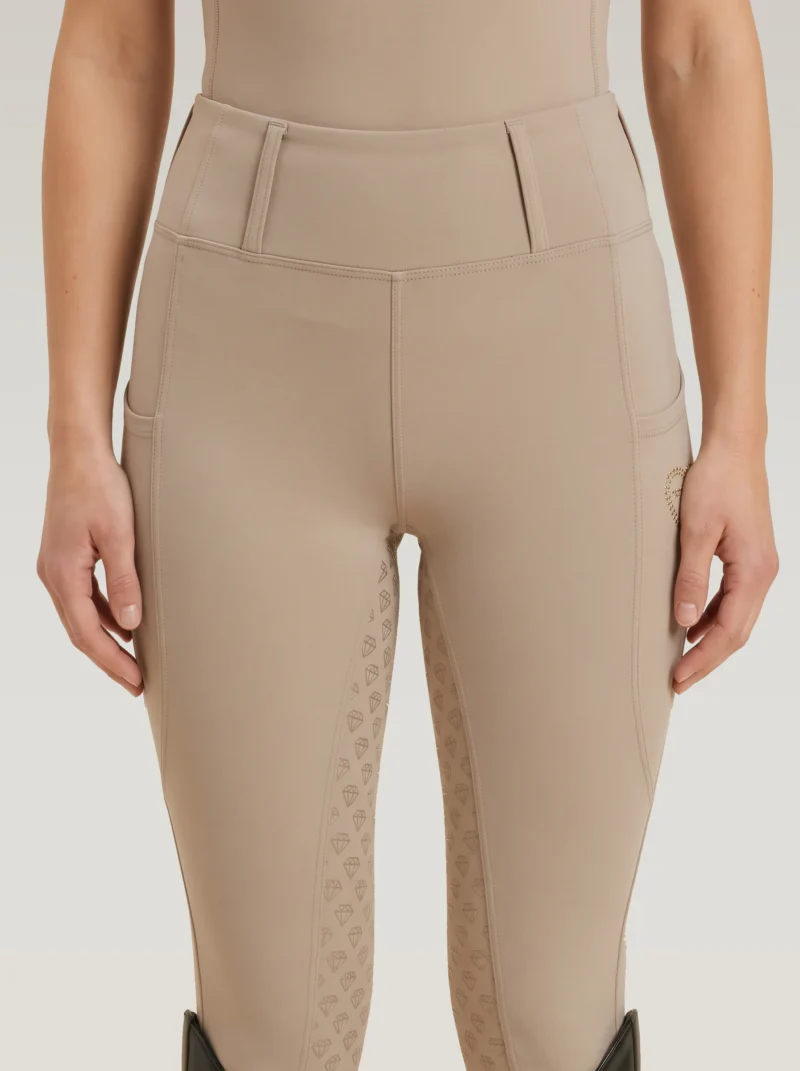 Front view of beige Prestige riding leggings by Diamont Equestrian with high-rise waistband and belt loops