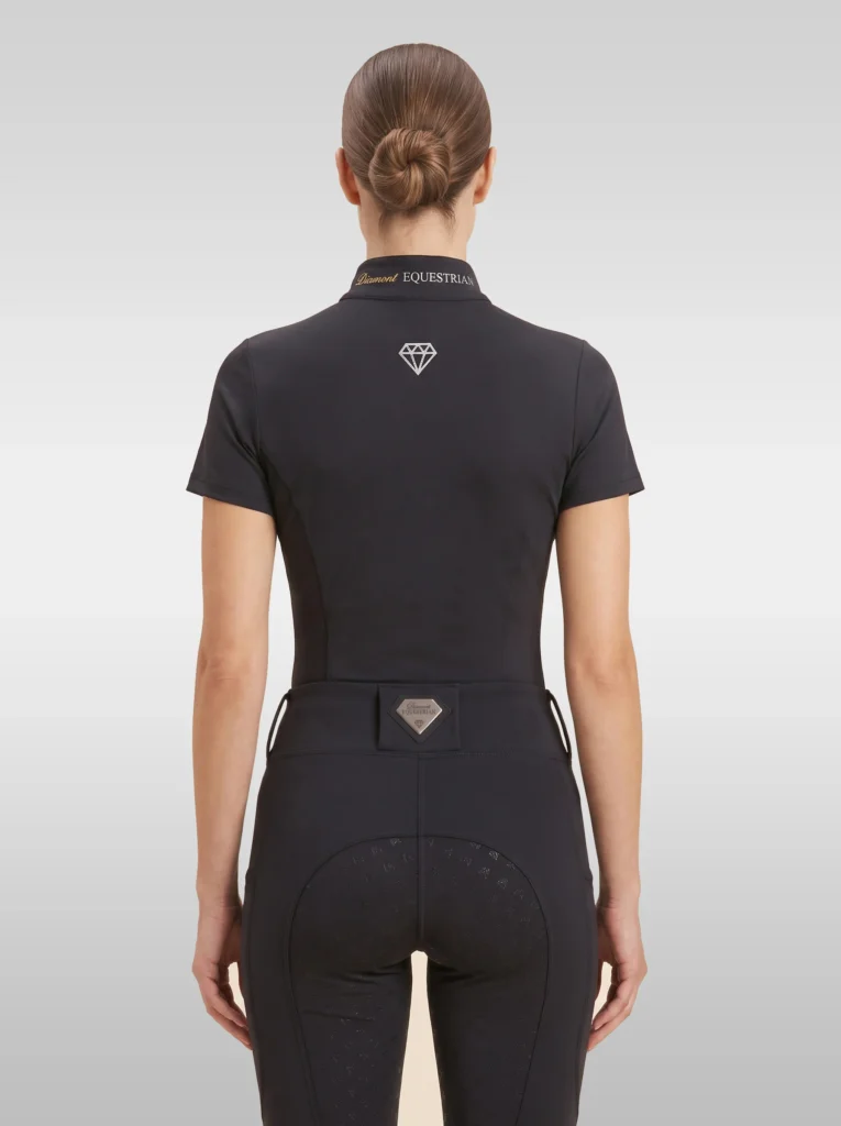 Back view of the black Prestige riding shirt with diamond logo between the shoulders and Diamont Equestrian lettering on the collar