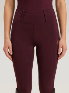Front view of burgundy Prestige riding leggings by Diamont Equestrian with high-rise waistband and belt loops