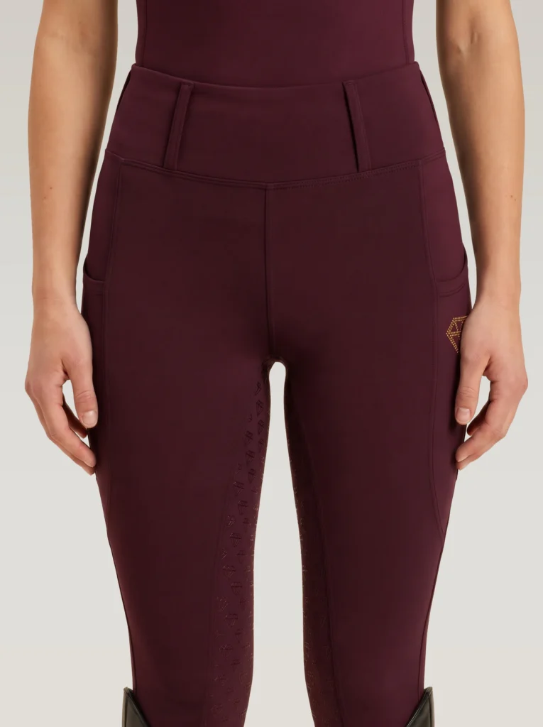 Front view of burgundy Prestige riding leggings by Diamont Equestrian with high-rise waistband and belt loops