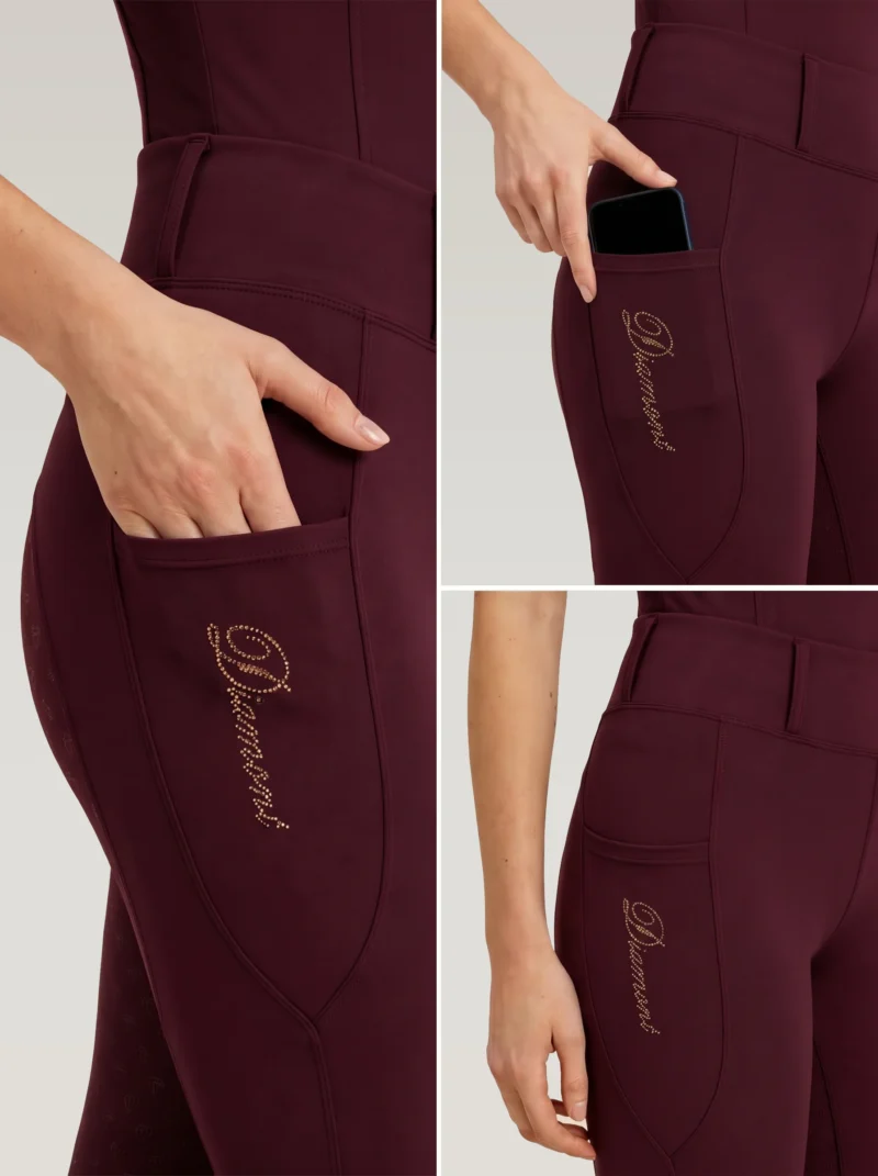 Close-up details of burgundy riding leggings: side phone pocket holding a smartphone and Diamont script