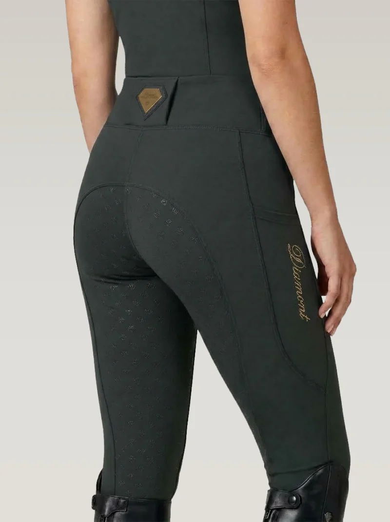 Back three-quarter view of green equestrian leggings with full-seat diamond grip, waistband badge and Diamont script