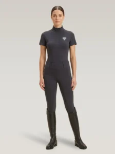 Rider wearing grey Prestige riding leggings with a matching Diamont Equestrian base layer and tall riding boots, full body