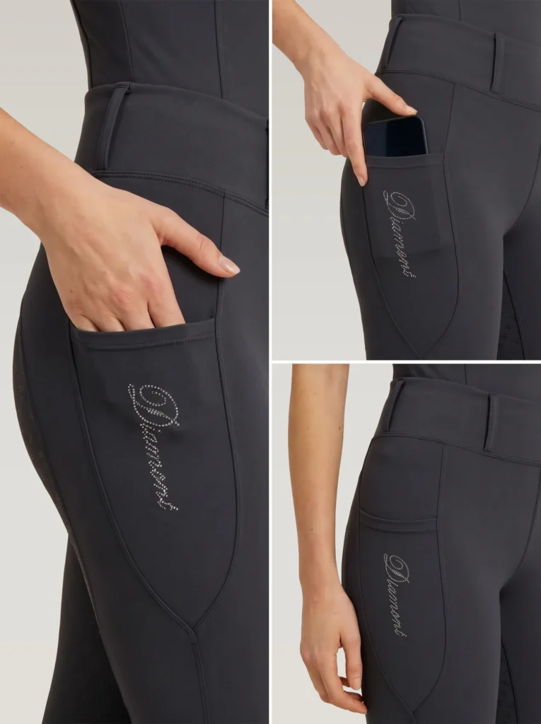 Close-up details of grey riding leggings: side phone pocket holding a smartphone and Diamont script