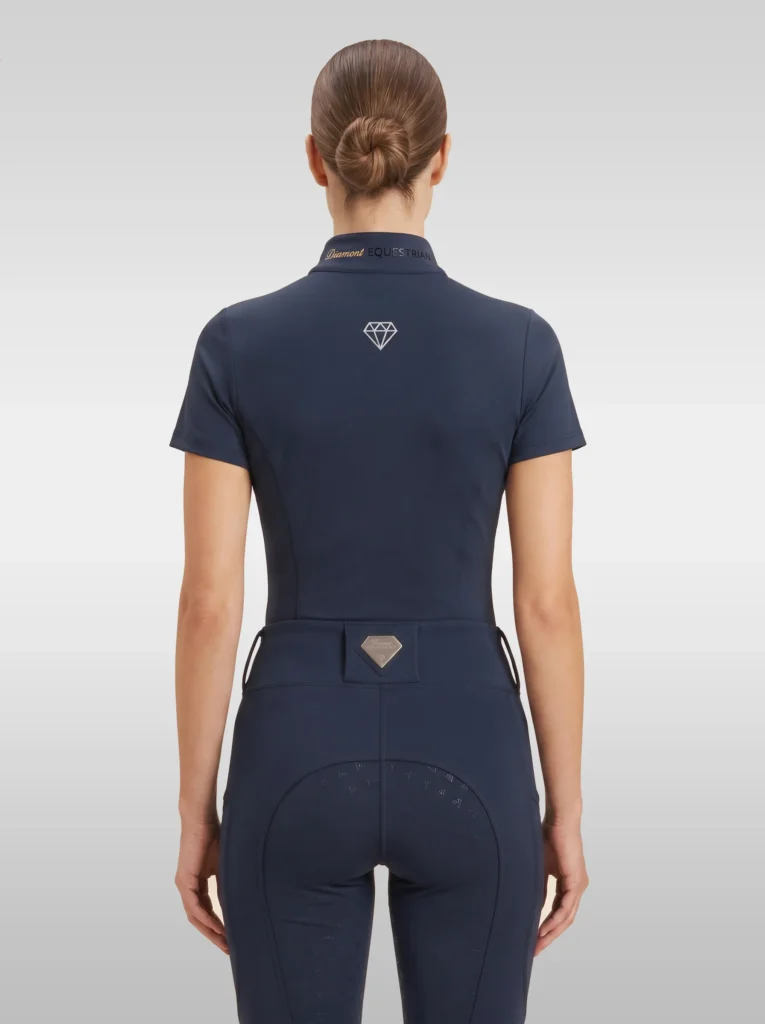 Back view of the navy Prestige riding shirt with diamond logo between the shoulders and Diamont lettering on the collar