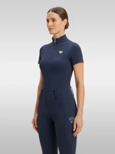 Navy Prestige base layer by Diamont Equestrian with silver quarter-zip and silver metal diamond badge on the chest, front three-quarter view
