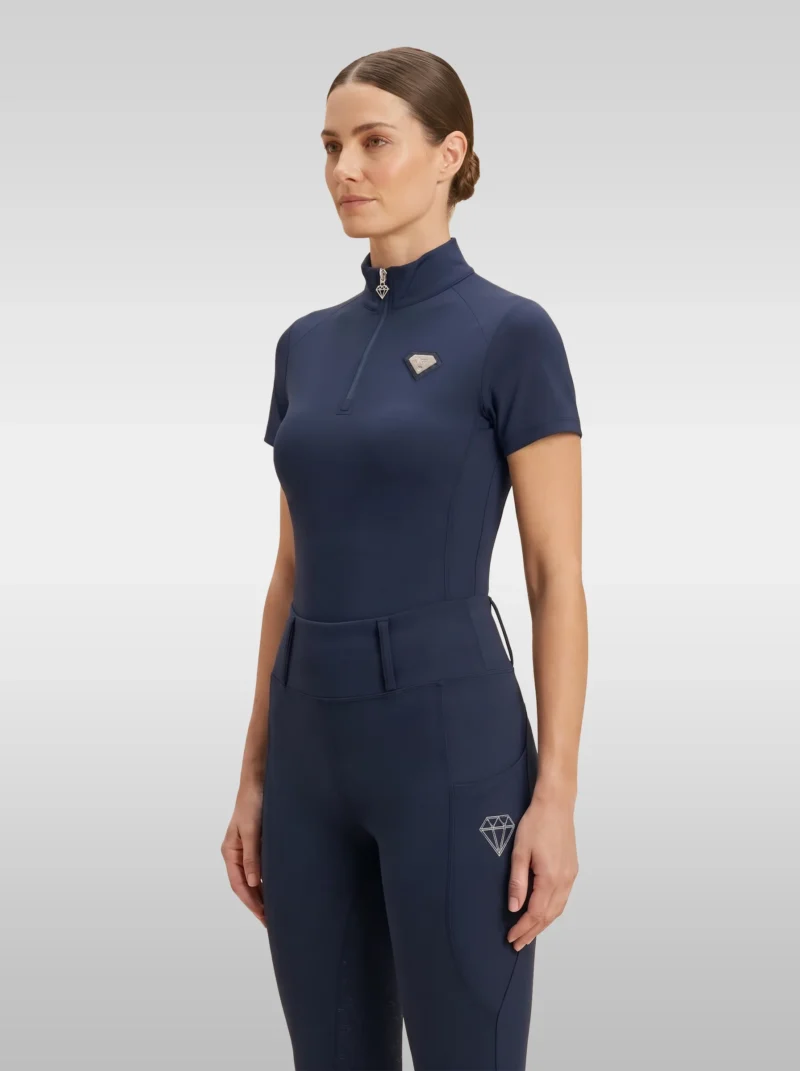 Navy Prestige base layer by Diamont Equestrian with silver quarter-zip and silver metal diamond badge on the chest, front three-quarter view