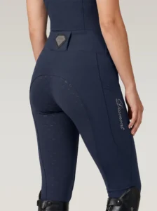 Back three-quarter view of navy equestrian leggings with full-seat diamond grip, waistband badge and Diamont script