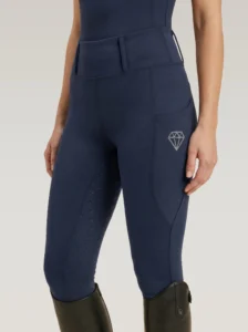 Navy Prestige riding leggings by Diamont Equestrian with diamond logo on the side pocket and diamond silicone grip, front three-quarter view