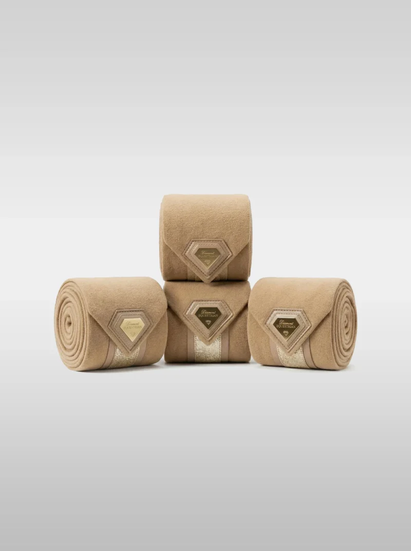 Set of four beige Prestige fleece polo wraps by Diamont Equestrian with a metal diamond badge in a leather frame