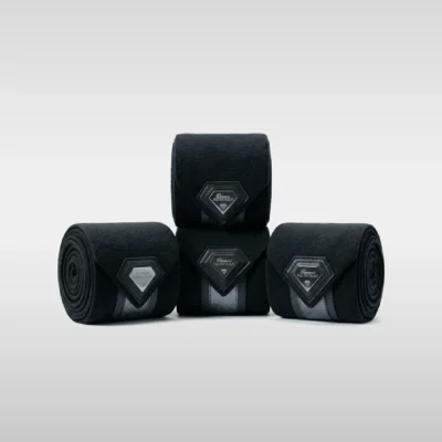 Set of four black Prestige fleece polo wraps by Diamont Equestrian with a metal diamond badge in a leather frame