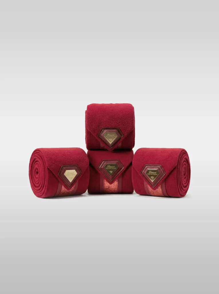 Set of four burgundy Prestige fleece polo wraps by Diamont Equestrian with a metal diamond badge in a leather frame