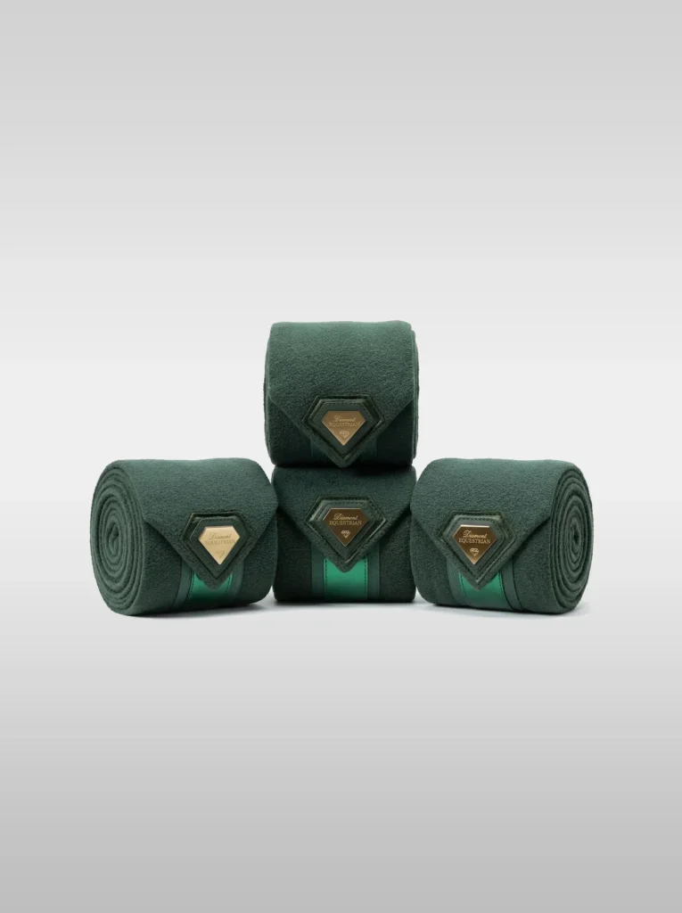 Set of four green Prestige fleece polo wraps by Diamont Equestrian with a metal diamond badge in a leather frame