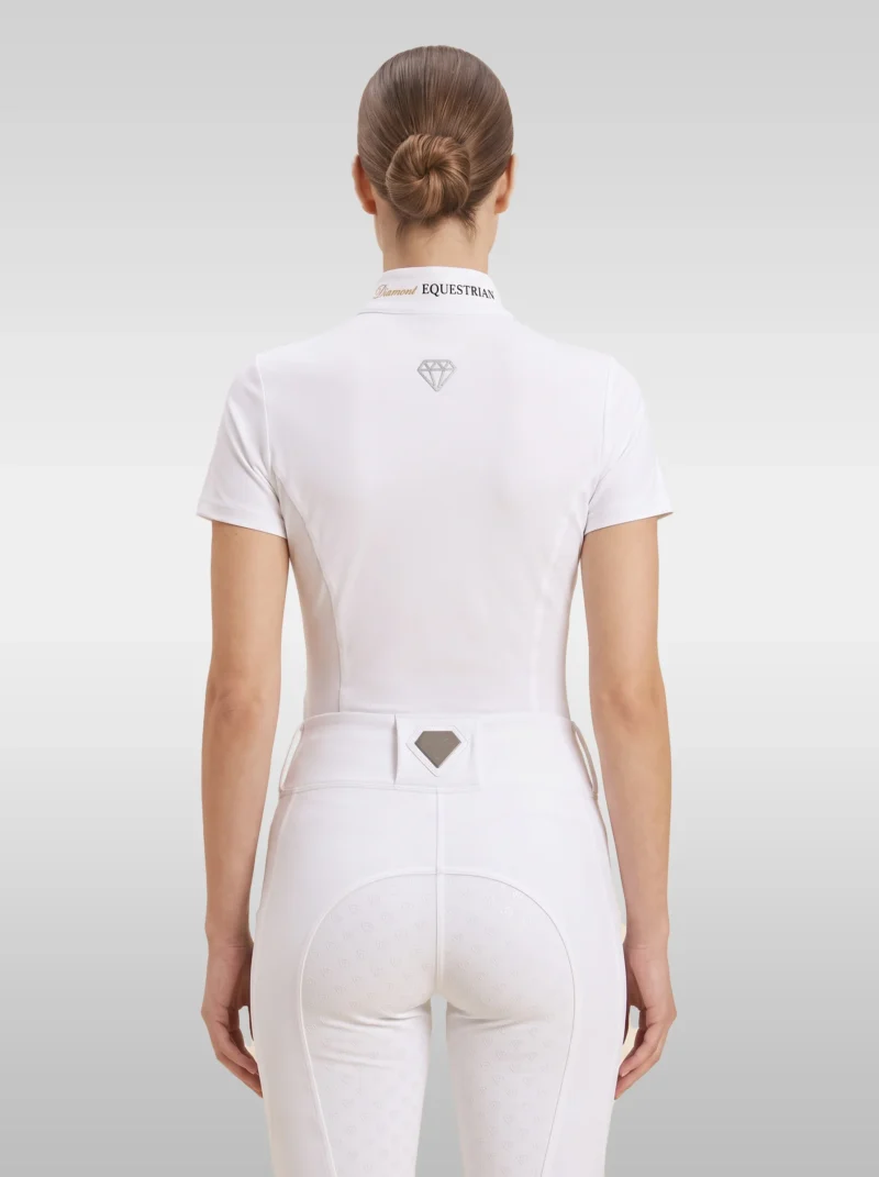 Back view of the white Prestige riding shirt with diamond logo between the shoulders and Equestrian lettering on the collar