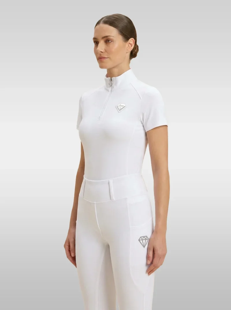 White Prestige base layer by Diamont Equestrian with silver quarter-zip and silver metal diamond badge on the chest, front three-quarter view