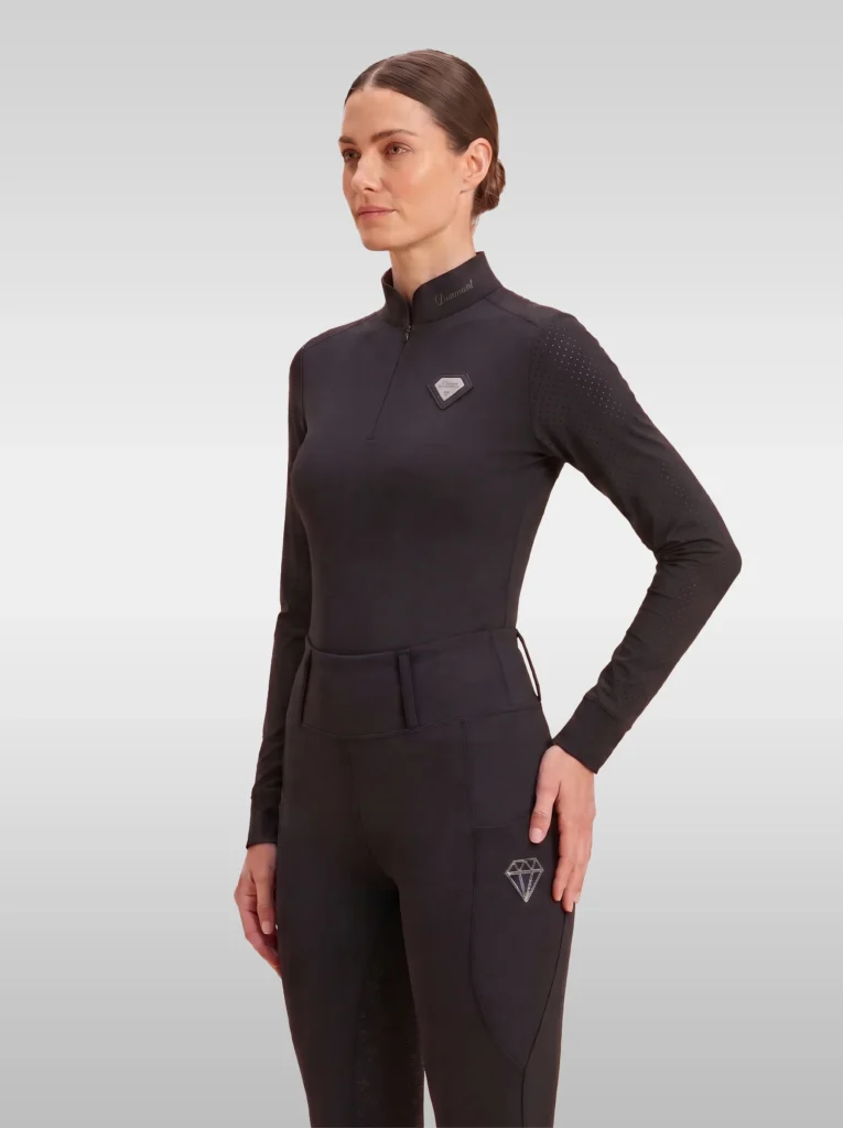 Black Prestige long sleeve base layer by Diamont Equestrian with quarter-zip, perforated shoulders and silver metal diamond badge, front three-quarter view