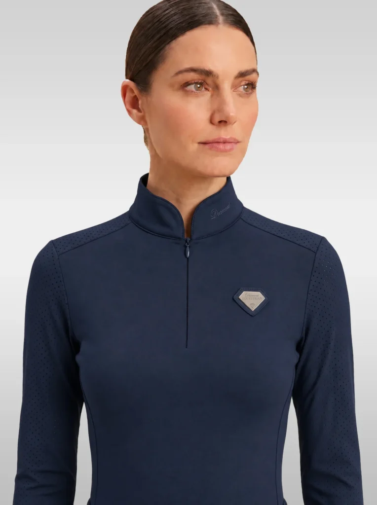 Front view of the navy Prestige long sleeve base layer by Diamont Equestrian with high collar, zip and silver diamond badge