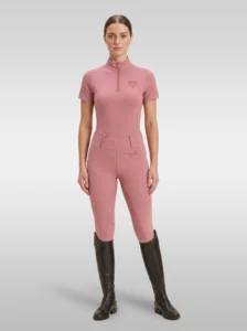 Rider wearing the blush pink Allure base layer with matching Allure riding leggings and tall riding boots, full body