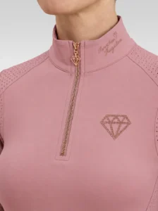 Close-up of the blush pink Allure base layer: rose-gold zip with diamond pull, signature on the collar and diamond logo on the chest