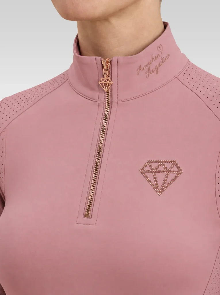 Close-up of the blush pink Allure base layer: rose-gold zip with diamond pull, signature on the collar and diamond logo on the chest