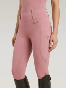 Blush Pink Allure riding leggings by Diamont Equestrian with diamond logo on the side pocket and diamond silicone grip, front three-quarter view