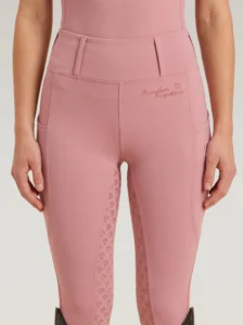 Front view of blush pink Allure riding leggings by Diamont Equestrian with high-rise waistband and belt loops