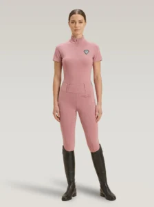 Rider wearing blush pink Allure riding leggings with a matching Diamont Equestrian base layer and tall riding boots, full body