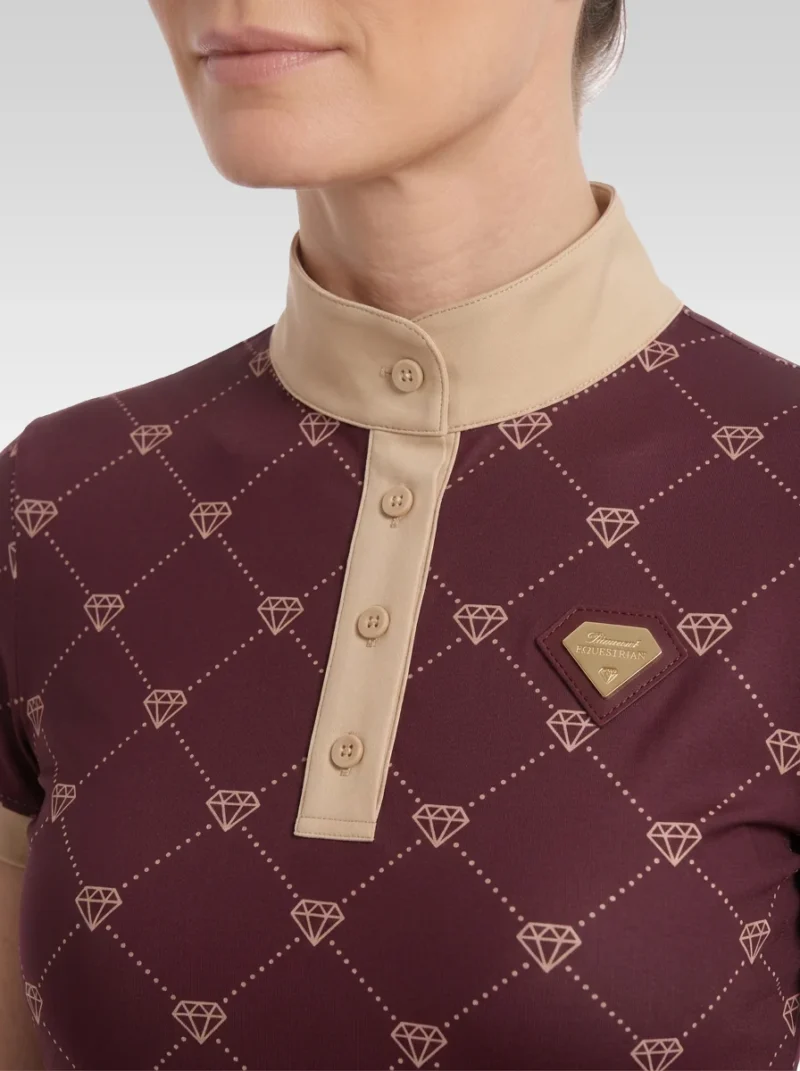 Close-up of the burgundy Diamont base layer: beige stand-up collar, button placket, gold diamond monogram print and gold metal diamond badge