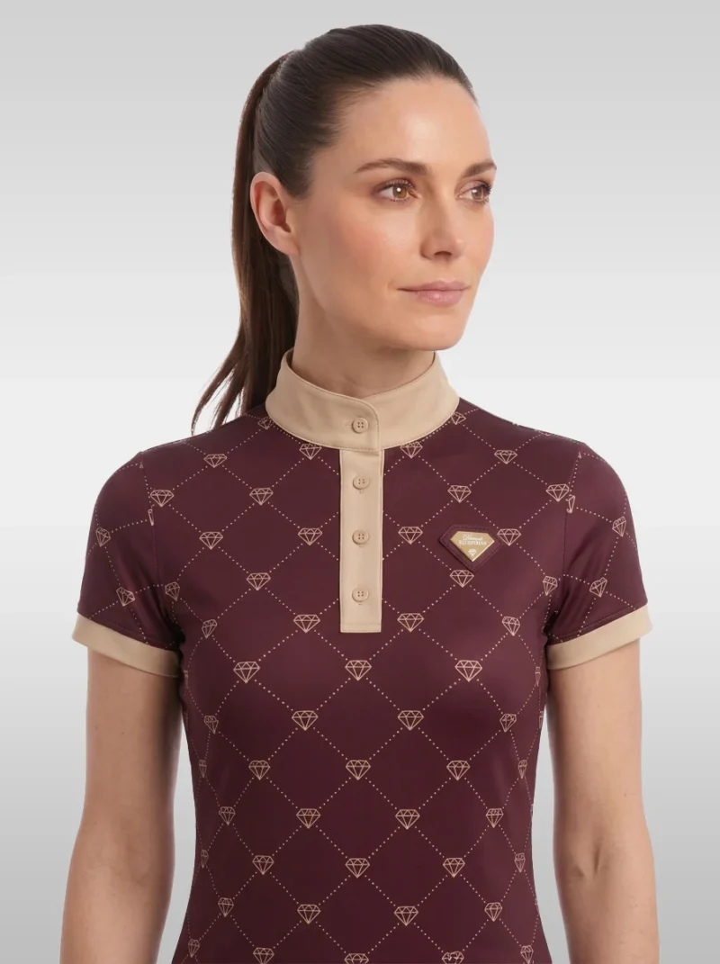 Front view of the burgundy Diamont equestrian base layer with beige buttoned placket, stand-up collar and gold diamond badge