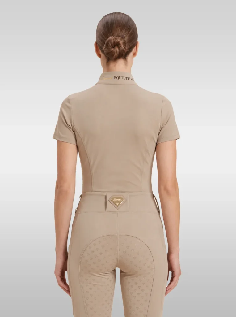 Back view of the beige Prestige riding shirt with Equestrian lettering on the collar