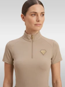 Front view of the beige Prestige base layer by Diamont Equestrian with high collar, gold zip and diamond badge