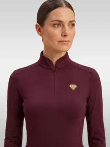 Front view of the burgundy Prestige long sleeve base layer by Diamont Equestrian with high collar, zip and gold diamond badge