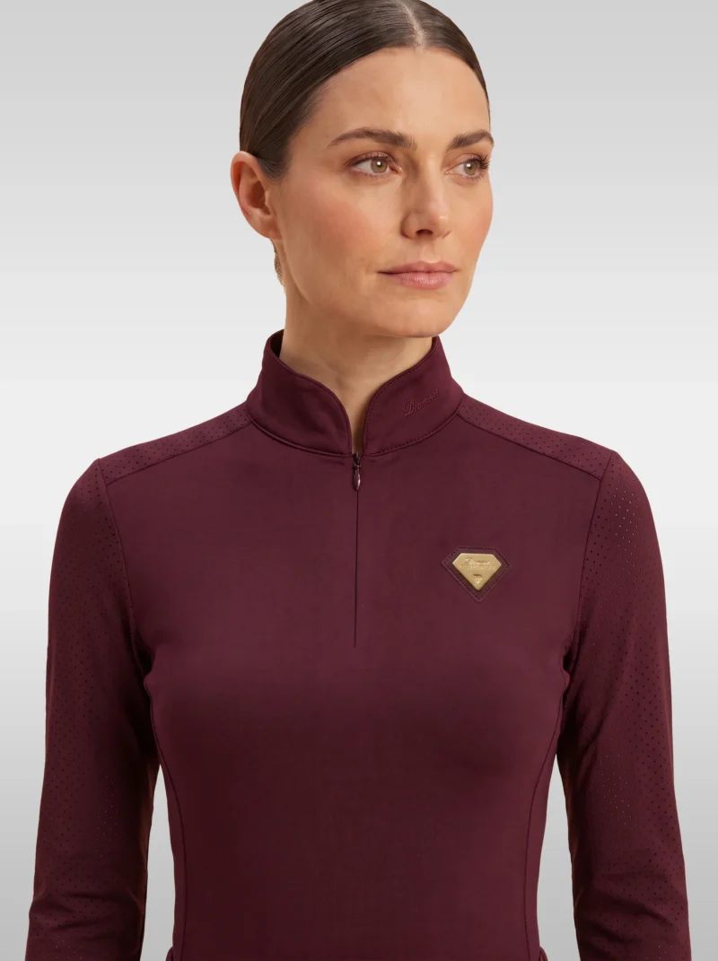 Front view of the burgundy Prestige long sleeve base layer by Diamont Equestrian with high collar, zip and gold diamond badge