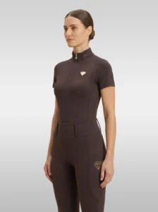 Chocolate brown Prestige base layer by Diamont Equestrian with gold quarter-zip and gold metal diamond badge on the chest, front three-quarter view