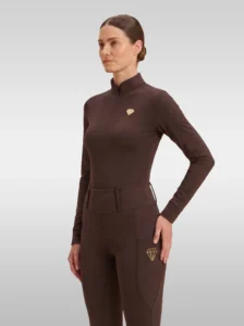 Chocolate brown Prestige long sleeve base layer by Diamont Equestrian with quarter-zip, perforated shoulders and gold metal diamond badge, front three-quarter view