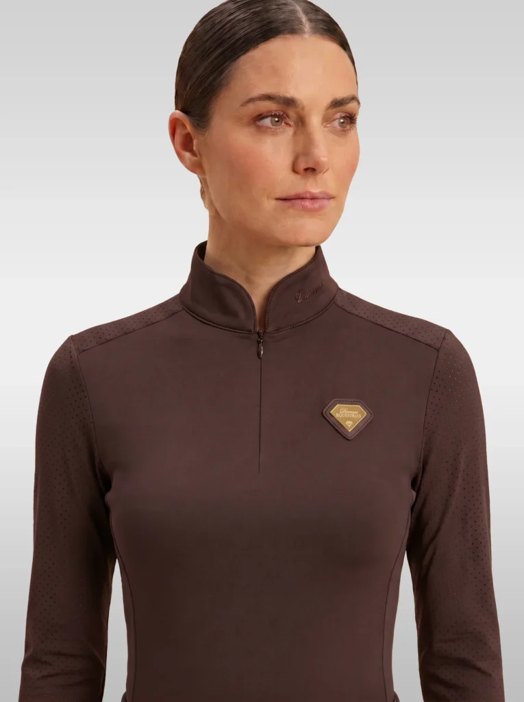 Front view of the chocolate brown Prestige long sleeve base layer by Diamont Equestrian with high collar, zip and gold diamond badge