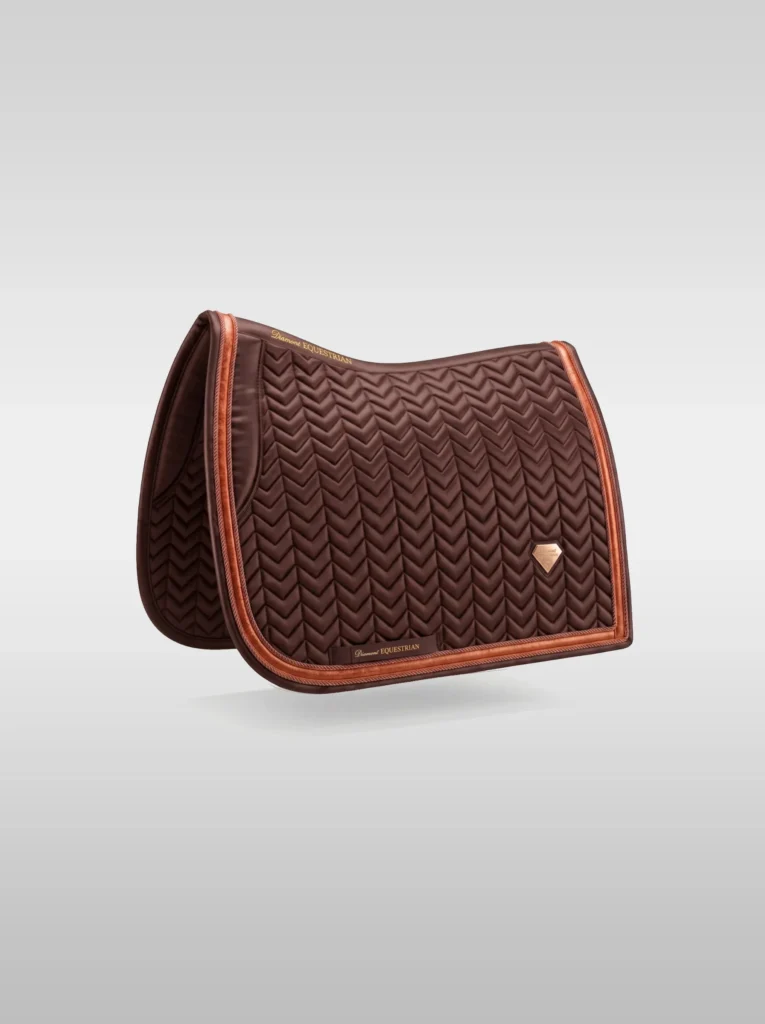 Chocolate Prestige dressage saddle pad by Diamont Equestrian with chevron quilting, contrast piping and a metal diamond badge