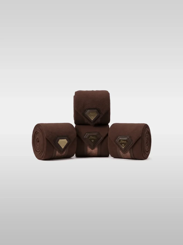 Set of four chocolate Prestige fleece polo wraps by Diamont Equestrian with a metal diamond badge in a leather frame