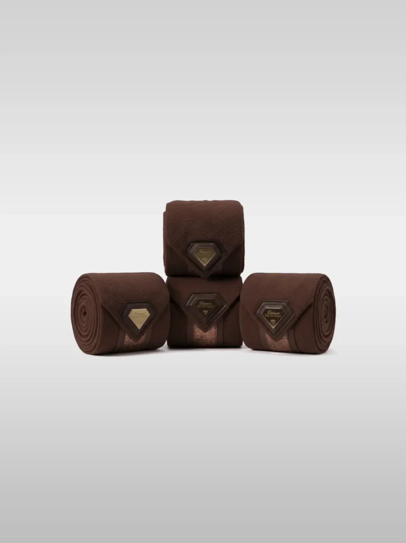 Set of four chocolate Prestige fleece polo wraps by Diamont Equestrian with a metal diamond badge in a leather frame